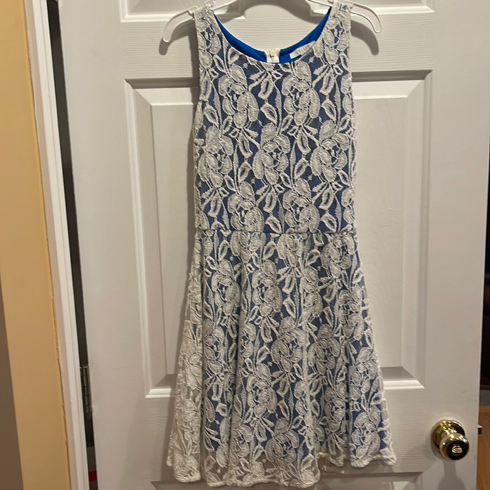 Like new juniors cream homecoming dress. Lace pattern and royal blue lining.
